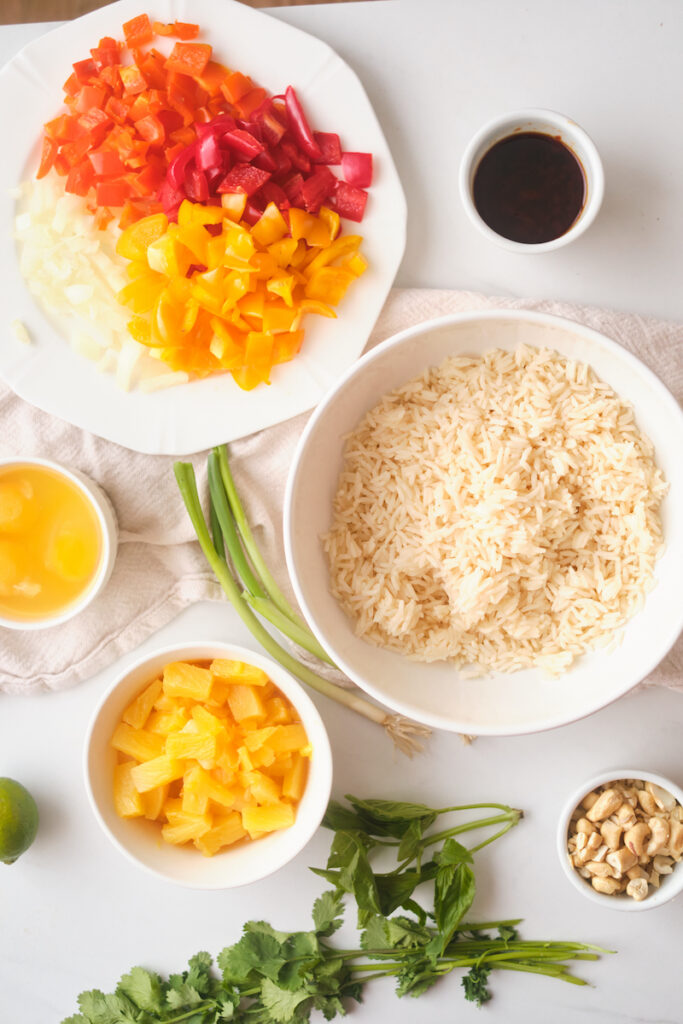 ingredients for thai pineapple fried rice separated out into bowls