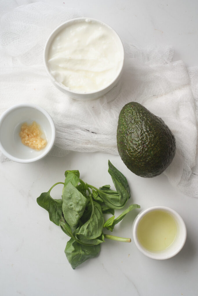 ingredients for basil avocado yoghurt dressing to use on a sweet potato buddha bowl