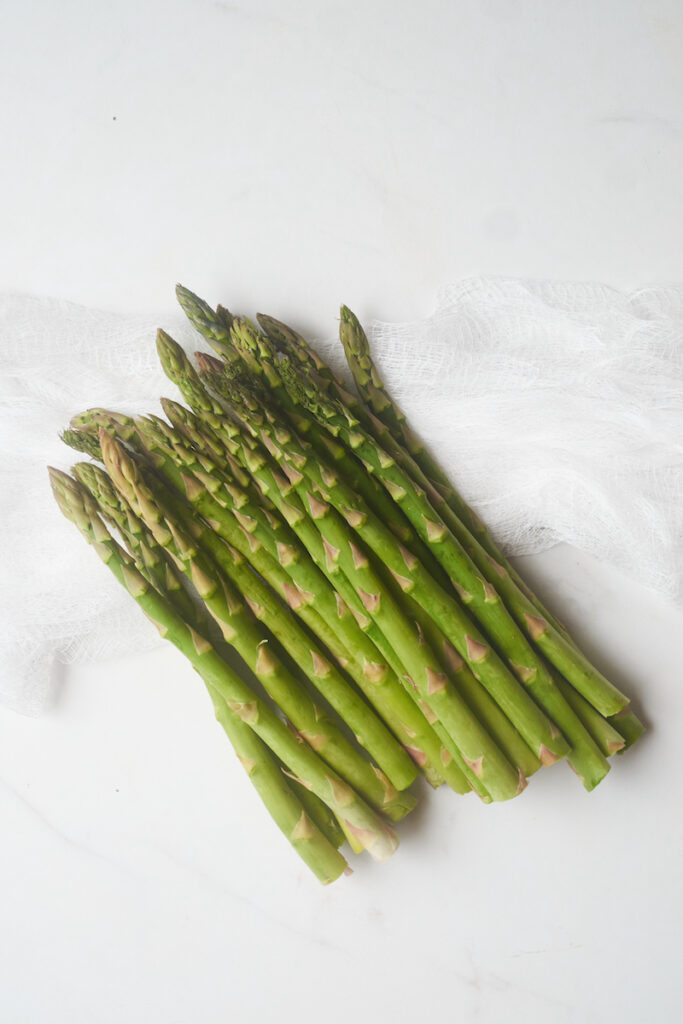 bright green tender asparagus spears on a white counter