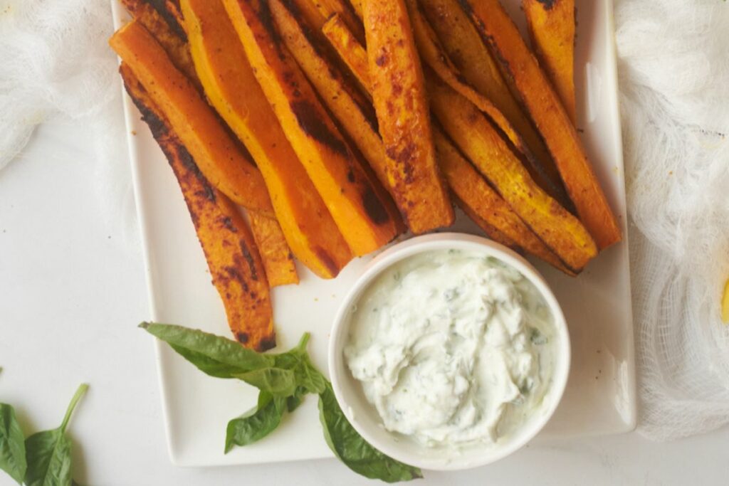 curry yam fries with basil mint yoghurt dip on a serving dish