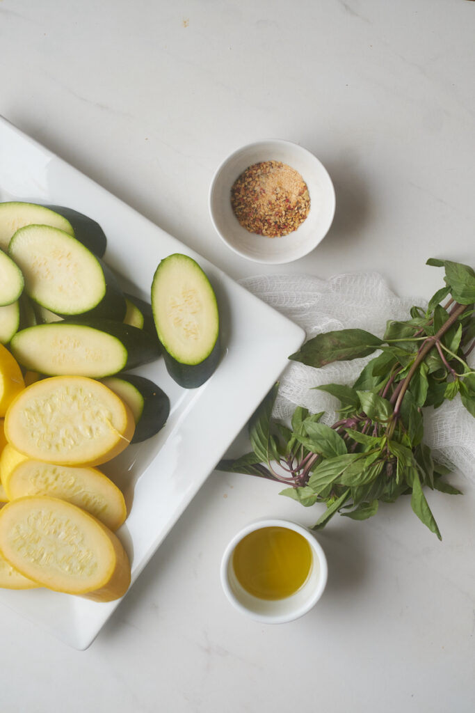ingredients for a grilled zucchini and summer squash with basil recipe