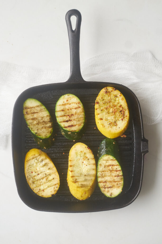grilled zucchini and summer squash arranged on grill pan with grill marks