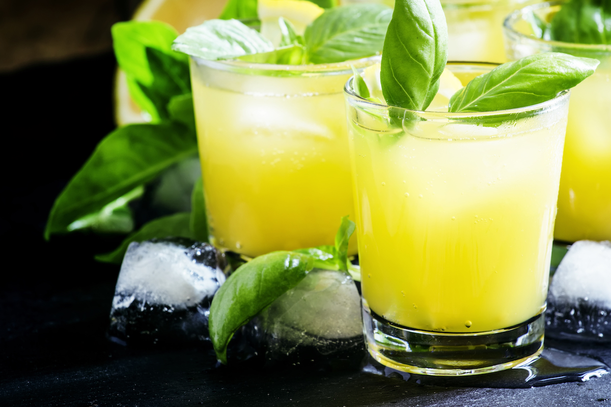 Alcoholic cocktail Basil smash with green basil, gin, sugar syrup, lemon juice and ice. Basil gin smash is one of the most popular cocktails with basil