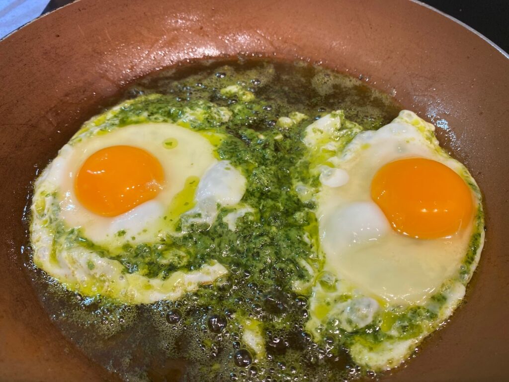 pesto eggs in a frying pan