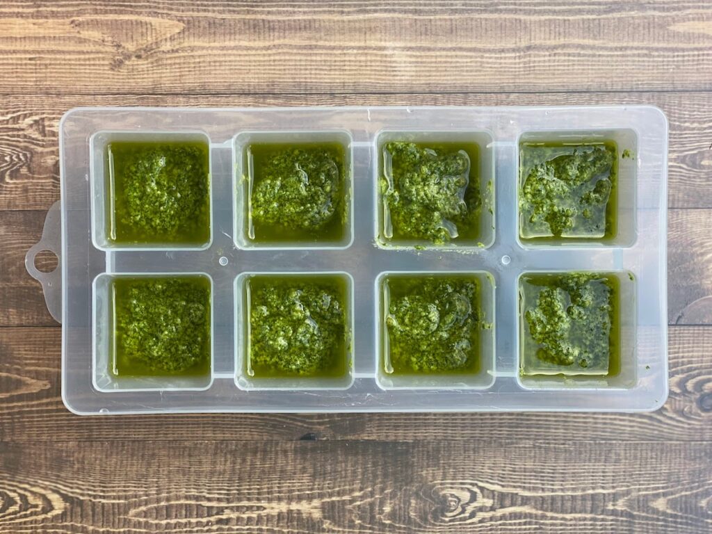 Pesto in an ice cube tray before freezing