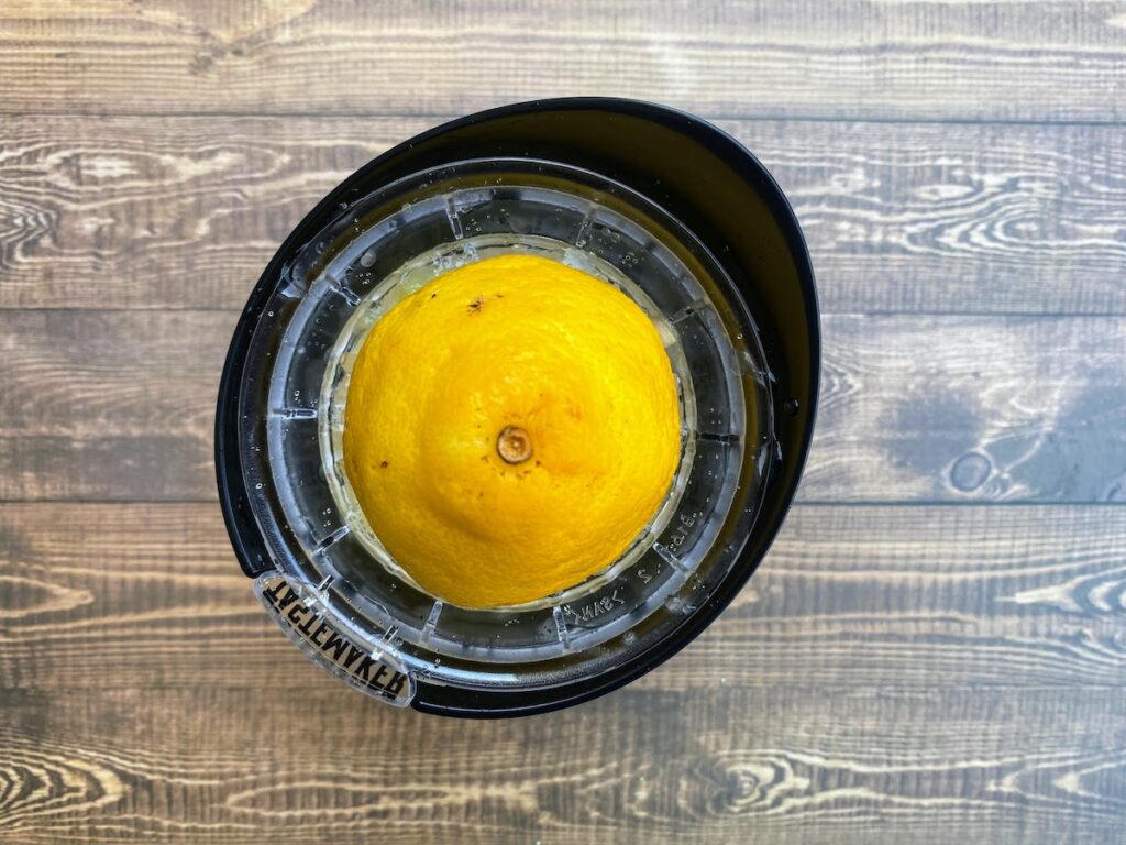 Birdseye view of a lemon half on a handheld juicer
